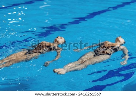 Synchronized swimming duet perfects their routine in dedicated training, blending skill and artistry with every fluid movement Stock foto © 