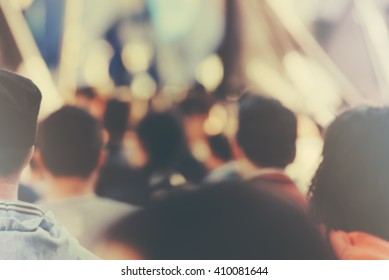 Syndicate and union concept. Blur unrecognizable crowd at political meeting, cheering audience looking at the stage and supporting political party, defocused retro toned image with lens flare. - Shutterstock ID 410081644