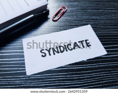 Syndicate writting on table background.