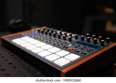 Synthesizer board with push pad buttons and volume regulators. Professional audio equipment for electronic music production. Hip hop music producer hardware to compose musical tracks