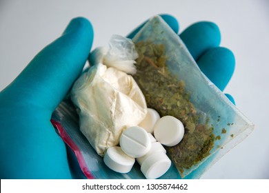 Synthetic Drugs: Laboratory Assistant Holds Samples Of Narcotic Herbal Medicines In His Hand