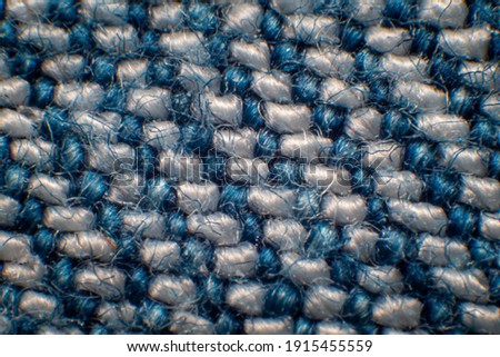 Synthetic fiber photos of denim There is a space between the fibers. Tidy weave, blue-white fibers, high magnification, super macro.