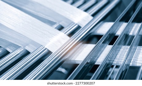 synthetic textile thread,  thread at industrial weaving manufacturing machine,  textile fabric production industrial concept background - Shutterstock ID 2277300207