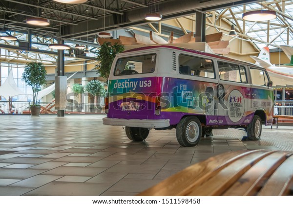Syracuse, New York- NOV 6,\
2017: Landscape View of Destiny USA Mall Parked VW Van with\
Promotional Ads on.