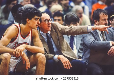 SYRACUSE, NEW YORK, USA - Coach Jim Boeheim Talks To Player Rony Seikaly During Syracuse Orangemen College NCAA Basketball Game In Carrier Dome, 1980s