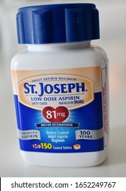 Syracuse, New York, USA - February 21, 2020: Closeup Illustrative Editorial Of A St. Joseph Adult Low Dose Aspirin Bottle Used To Manage Heart Health