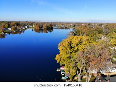 Syracuse, New York, U.S.A - October 19, 2019 - The aerial view of the waterfront homes by Oneida Lake with stunning fall foliage