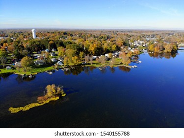 Syracuse, New York, U.S.A - October 19, 2019 - The aerial view of the waterfront homes by Oneida Lake with stunning fall foliage