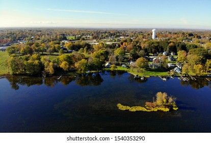 Syracuse, New York, U.S.A - October 19, 2019 - The aerial view of the waterfront residential area by Oneida Lake with stunning fall foliage
