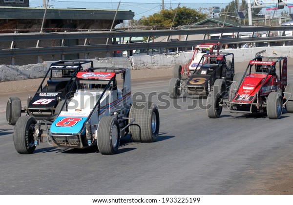 \
Syracuse, NY, USA - October 10, 2015:  A\
pack of USAC Silver Crown cars prepares to take the green flag\
during Super Dirt Week at the historic Syracuse Fairgrounds dirt\
track.				
