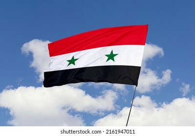 Syria flag is isolated on the blue sky with a clipping path. flag symbols of Syria.