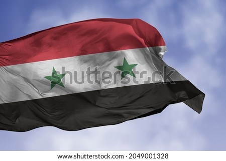 Syria flag isolated on the blue sky with clipping path. close up waving flag of Syria. flag symbols of Syrian.