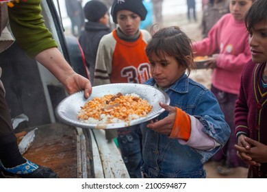 Syria - October 2017: Syrian Refugees In The Syrian Border Region Are Struggling To Survive In Cold Weather Conditions.Children Queuing For Food.