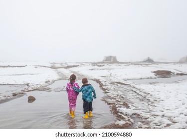 Syria - October 2017: Syrian refugees in the Syrian border region are struggling to survive in cold weather conditions. Two refugee children having fun regardless of the cold weather.