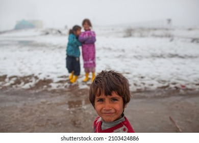 Syria - October 2017: Syrian refugees in the Syrian border region struggle to survive in cold weather conditions. Conditions are tough for children, too.