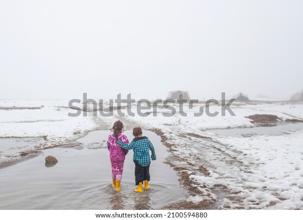 Syria\
- October 2017: Syrian refugees in the Syrian border region are\
struggling to survive in cold weather conditions. Two refugee\
children having fun regardless of the cold\
weather.
