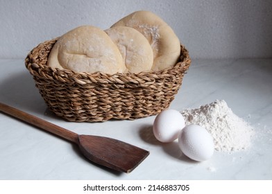 Syrian Bread Inside A Basket With Eggs And Flour Around