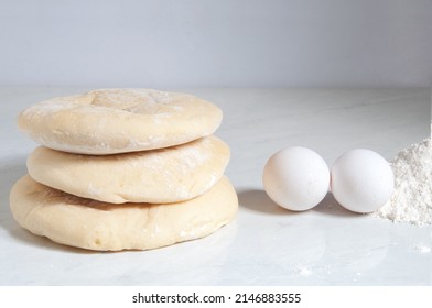 Syrian Bread On The Table With Eggs And Flour Around