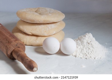 Syrian Bread On The Table With Eggs And Flour Around