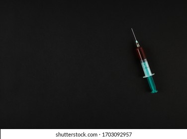 Syringe With Blood On Black Minimal Background. Room For Text. Lethal Desease, Test Concept With Copyspace.