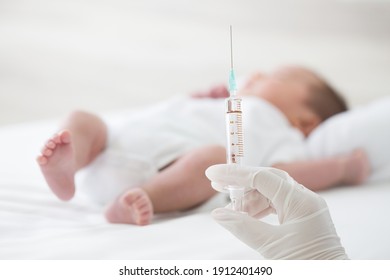 Syringe with blur baby background. Vaccine antivirus for infant concept