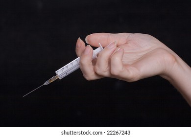 Syringe with a drug dose in a hand of the addict - Shutterstock ID 22267243