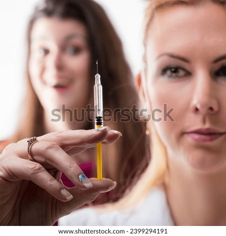 Syringe examination by a healthcare worker, observed by an apprehensive individual