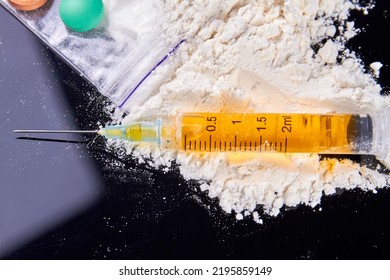 Syringe Filled With Drug Dose On The Pile Of White Powder. Drug Addiction Concept.