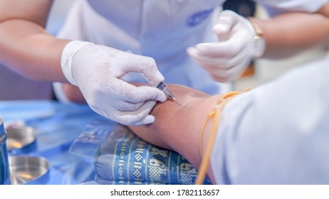 Syringe In The Hands. Medical Laboratory Technologist Taking A Blood Sample From Patient.