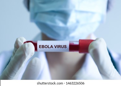 Syringe Injection Ebola Virus In Doctor's Hand .Medical Blood And Vaccine Chemistry Research.Hospital Equipment And Healthcare Concept