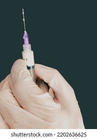 Syringe Injection Shot Jab With Needle Prick In Nurse Doctor's Gloves Worn Hand With Vaccine Medicine Drops Coming Out Isolated Closeup View Image Photo 