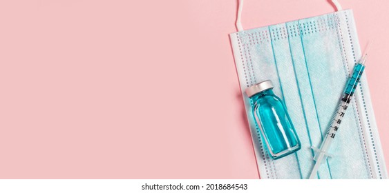 Syringe With Medicine From Glass Vial On A Pink Background, Flat Lay. Vaccination Against Influenza, Covid 19, Measles, Coronavirus Disease.