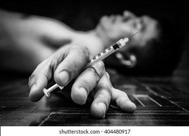 Syringe In Overdose Asian Male Drug Addict Hand, BW Photo