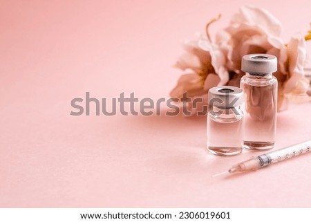 
Syringe and vial on pink background. Image of anti-aging beauty injections.