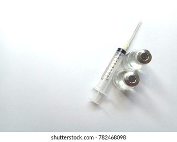 syringe and vials on a white background