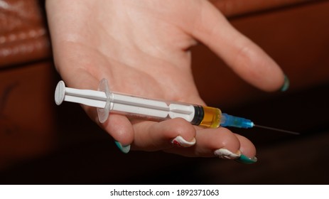 
Syringe in a woman's hand - Shutterstock ID 1892371063