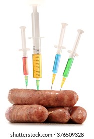 Syringes and meat isolated on white. Genetically modified food. GMO