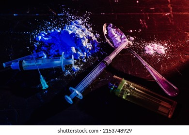 Syringes, Spoon, Drugs On A Black, Dimly Lit Surface. High View. Concept Of Illegal Substances, Prohibited Drugs, Substance Abuse, Hidden, Illegal Traffic.