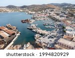 Syros island, Greece, Ermoupolis harbor aerial drone view. Boats moored at yachts marina dock. Industrial plant Neorion shipyard and cityscape, calm water. Cyclades Aegean Sea