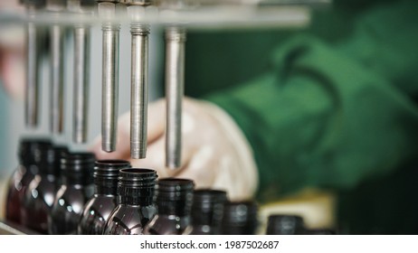 A Syrup Bottle Filling Machine In A Pharmaceutical Manufacturing Facility.               