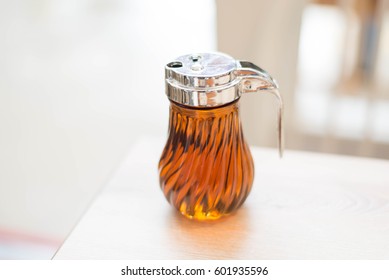 Syrup Bottle On Wood Table.