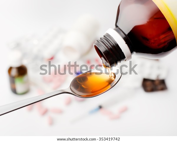 Syrup from bottle in spoon\
pouring