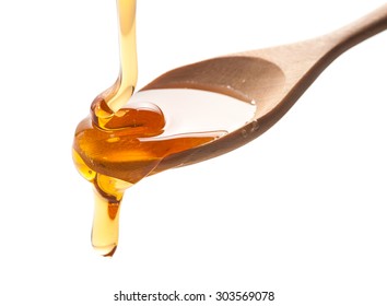 Syrup Pouring On Spoon On White Background