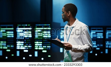 System administrator analysing server clusters performing data backups and providing centralized storage. Expert adjusting Uninterruptible Power Supply ensuring operational continuity
