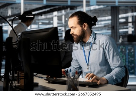 System administrator in data center doing software updates, verifying neural network parameters. Server hub IT expert using PC to inspect configurations, ensuring optimal application performance