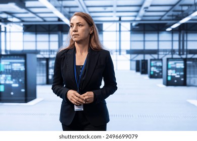 System administrator in data center identifying and solving technical issues related to data center infrastructure. IT expert managing, maintaining and securing high tech server hub environment