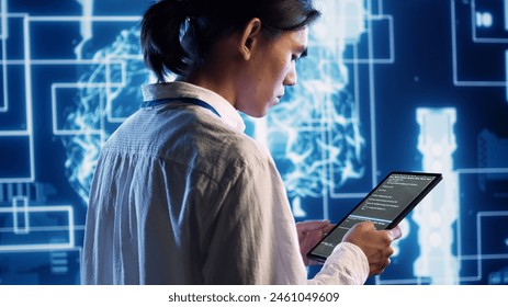 System administrator in data center running programming scripts on tablet, solving tasks. Experienced programmer manipulating lines of code for artificial intelligence applications development