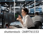System administrator in data center using AI powered tech to run simulations. Woman at work coding cognitive computing algorithms to extract insights from data and automate rigs