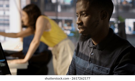 System administrator doing software quality assurance, checking source code on tablet. Close up of african american IT specialist at work inspecting coding on device, looking to fix errors, camera A - Powered by Shutterstock - Get 15% off with code: PIKWIZARD15