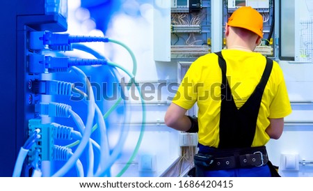 System administrator during work. Concept - the wizard configures the local network. Concept - Worker installs the Internet. LAN connection. Cables are connected to the server. Server hardware setup
